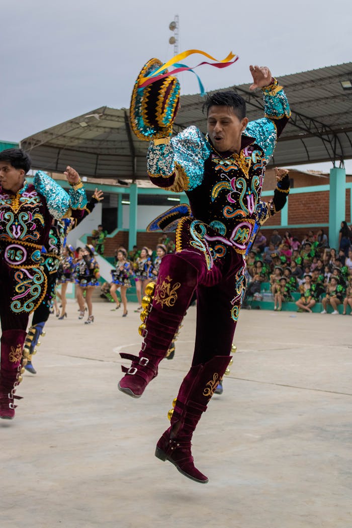 Energetic dancers in colorful traditional clothing performing at a festival in Imperial, Perú.
